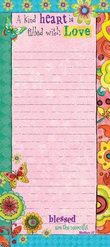 Colorful notepad with floral designs and motivational text on a pink background