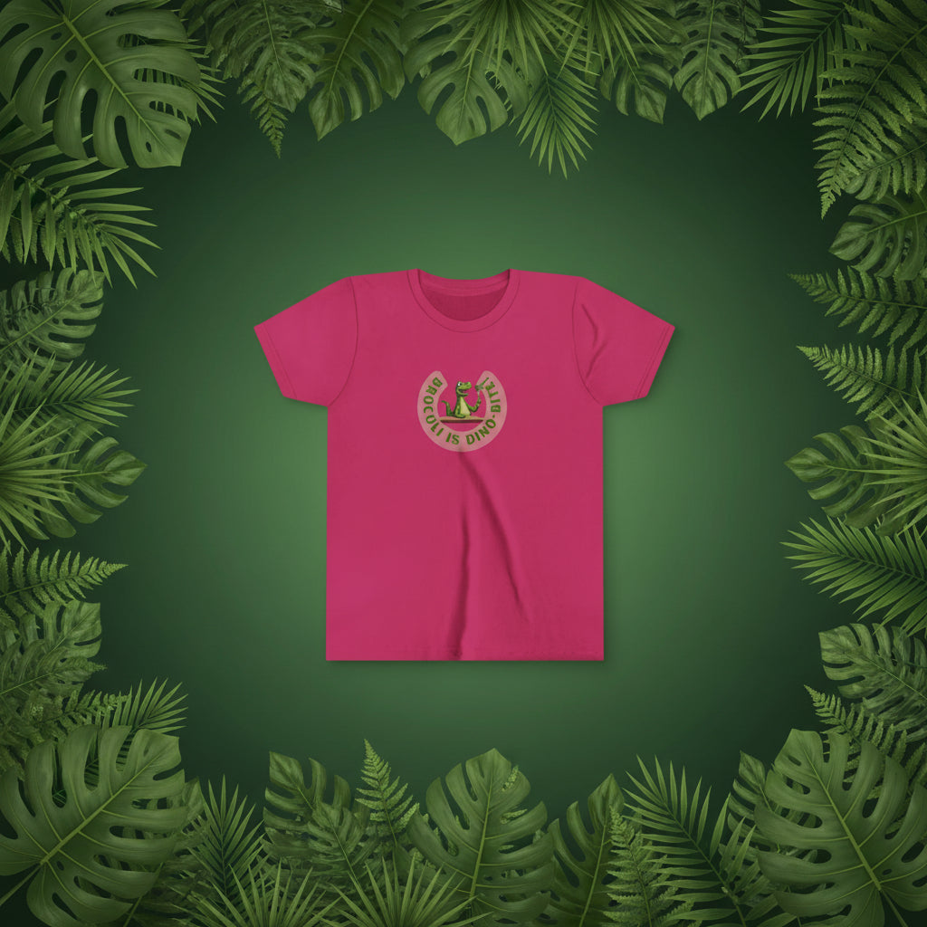 A raspberry pink short-sleeve crewneck t-shirt with a circular graphic on the chest showing a green dinosaur with broccoli on a fork and  Broccoli is dino-bite.