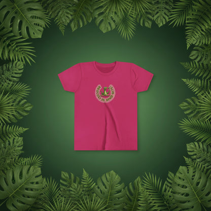 A raspberry pink short-sleeve crewneck t-shirt with a circular graphic on the chest showing a green dinosaur with broccoli on a fork and  Broccoli is dino-bite.