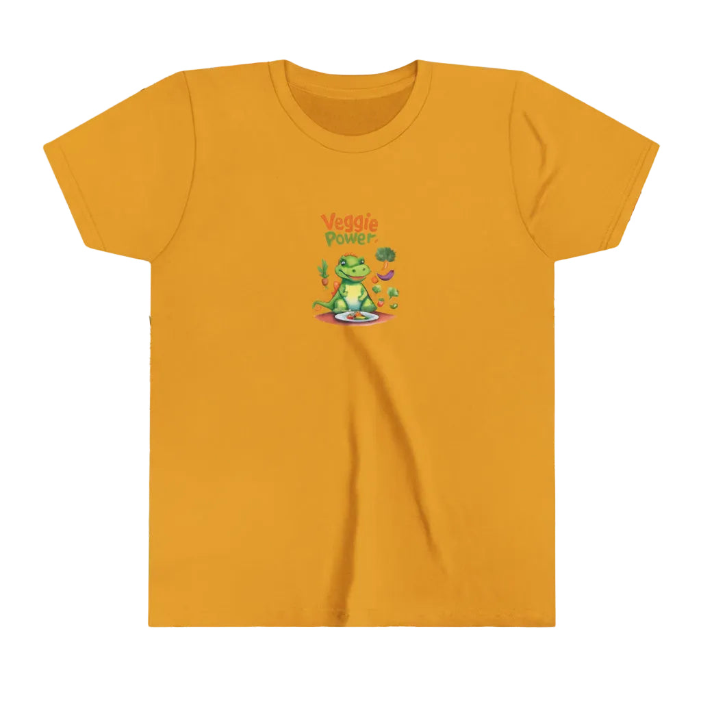 A mustard yellow short-sleeve t-shirt with a small cartoon graphic of a green dinosaur of aligator wearing a  sitting on a plate, with the text 'Veggie Power' above it, displayed on a fun, colorul background.