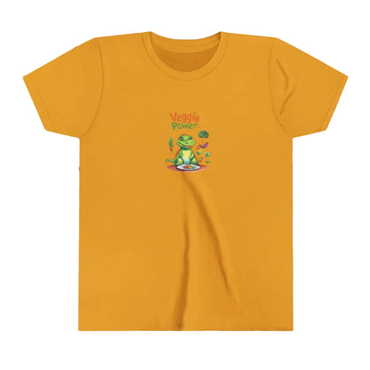 A mustard yellow short-sleeve t-shirt with a small cartoon graphic of a green dinosaur of aligator wearing a  sitting on a plate, with the text 'Veggie Power' above it, displayed on a fun, colorul background.