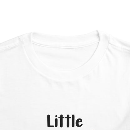 Close-up of a white short-sleeve tagless t-shirt showing the crew neck and the black text 'Little' printed on the chest.