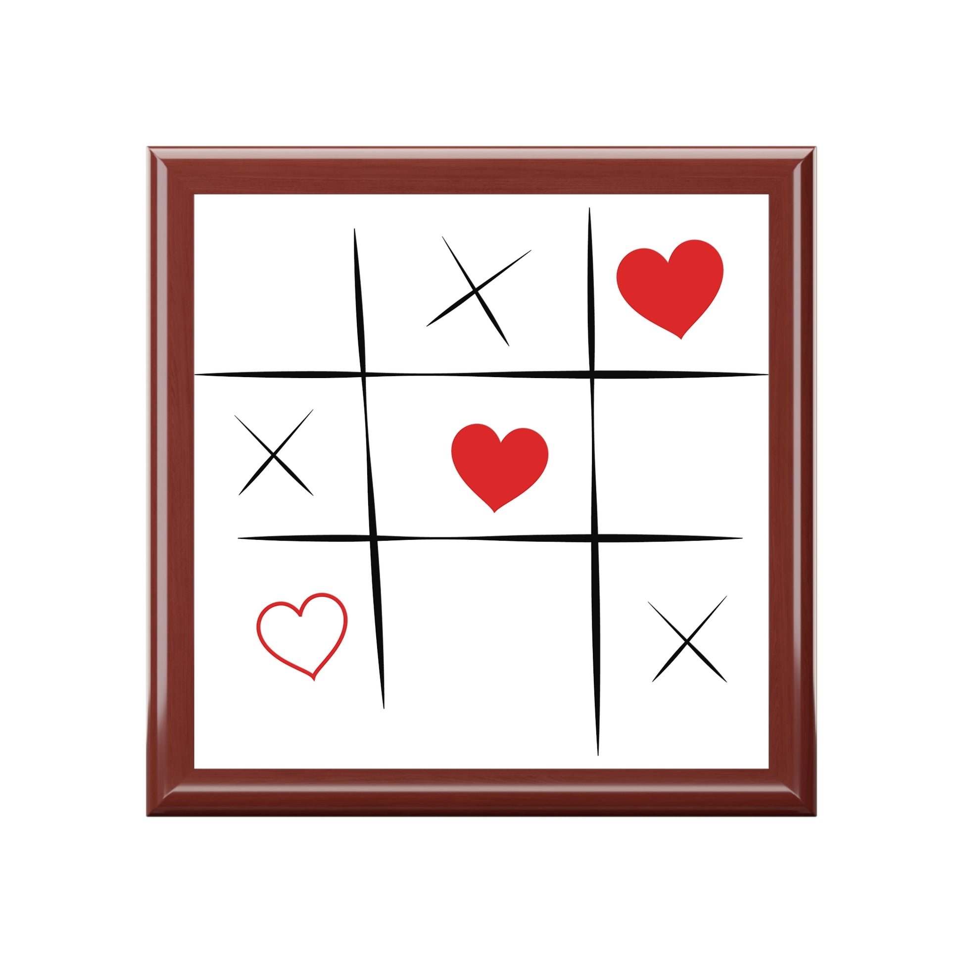 Tic-tac-toe board with hearts and 'X' marks inside a brown frame top of a jwery box on a white background