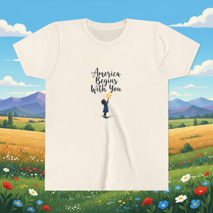 Beige t-shirt with 'America Begins With You' text and graphic on a white background
