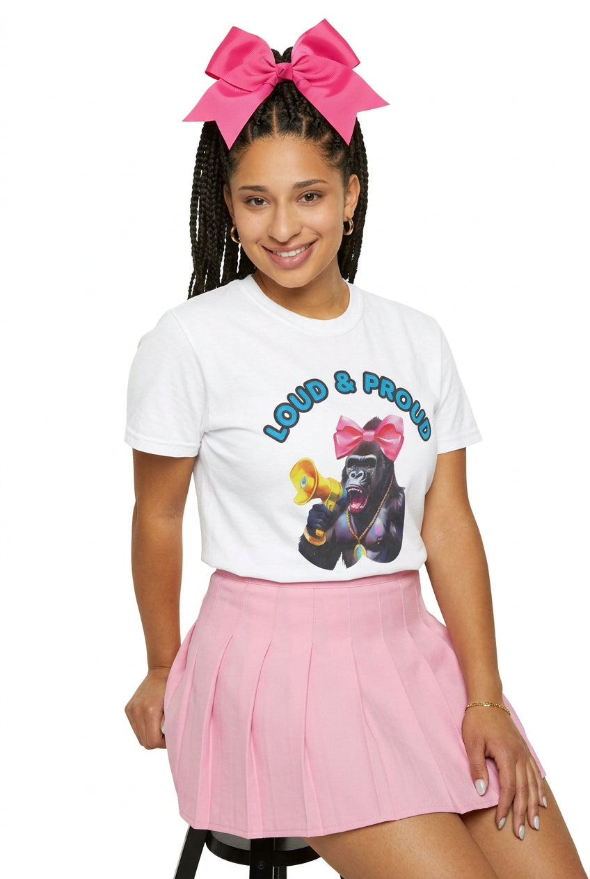 “Girl‑Girl™ cheerleader gorilla with pink bow and megaphone on a white unisex tee with the phrase ‘Loud & Proud.’” AI model cheerleader wears the tee with a pink cheerleader skirt.