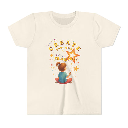 Beige t-shirt with a graphic of a girl drawing a star and the text 'Create your own magic' on a white background.