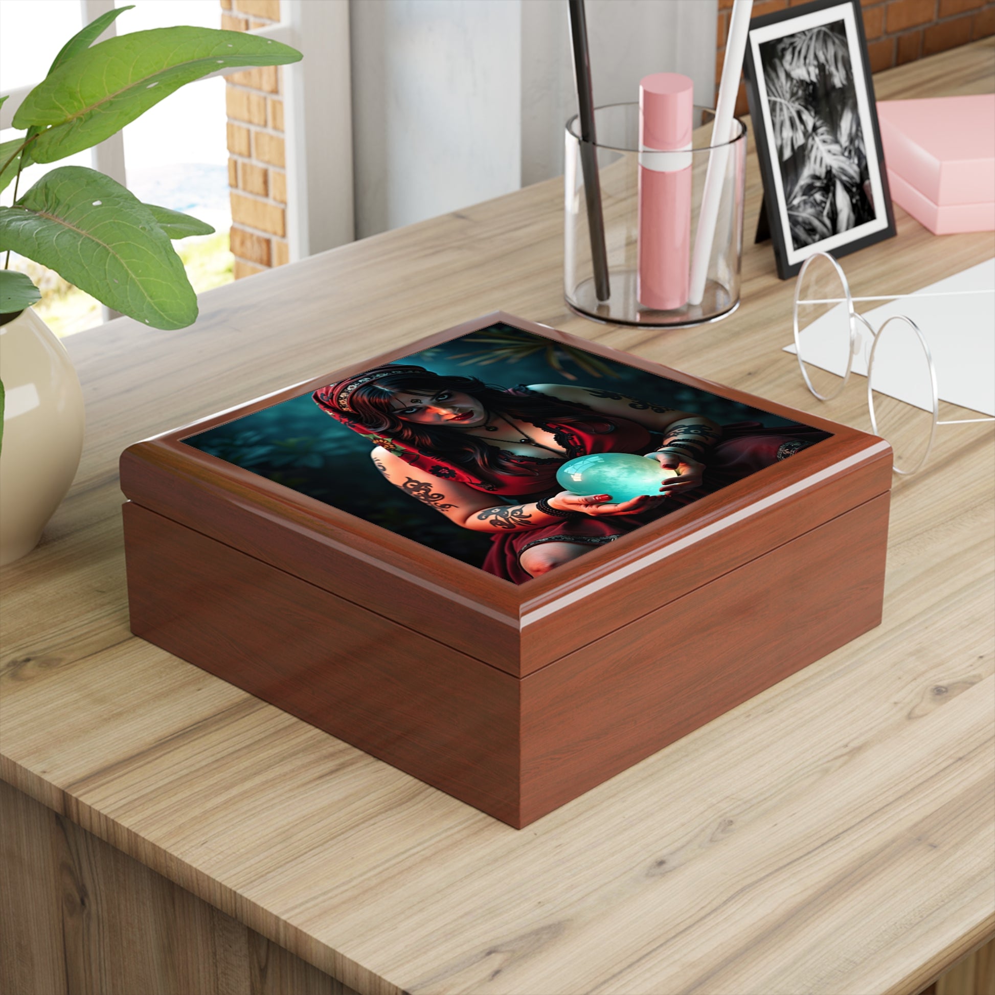 Wooden box with a colorful design of a woman holding a blue globe on a wooden surface