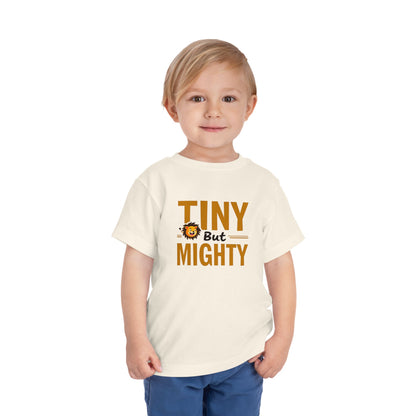 Child wearing a white t-shirt with 'Tiny But Mighty' text and a lion graphic on a white background