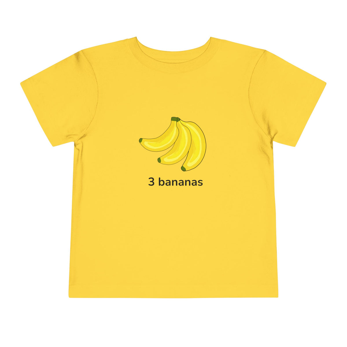 A yellow short-sleeve t-shirt with a graphic of three bananas and the text '3 bananas' printed on the chest, displayed on a solid white background. Toddler “3 bananas” T‑shirt in yellow – fruit counting design