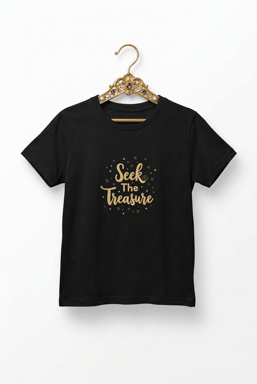Kids black T‑shirt with golden “Seek the Treasure” lettering surrounded by small star accents.