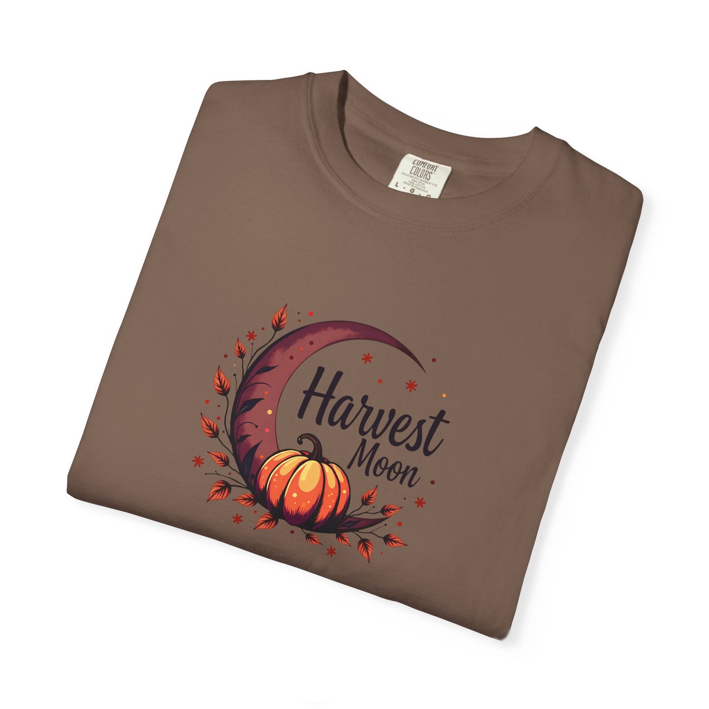 A folded hemp crewneck t-shirt with a 'Harvest Moon' graphic featuring a crescent moon, autumn leaves, and a pumpkin on a white background.