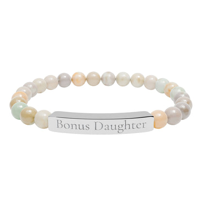 Beaded bracelet with a metal tag displaying 'Bonus Daughter' on a white background