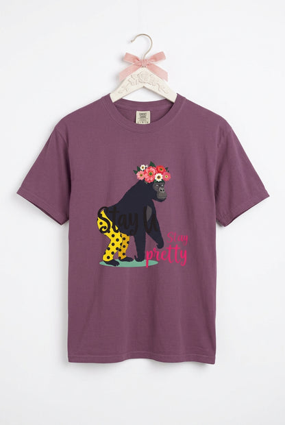 “Girl‑Girl™ gorilla wearing a flower crown and patterned shorts on a Berry unisex tee with the phrase ‘Stay Pretty.’”