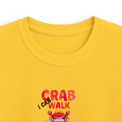 Close-up of a yellow crewneck t-shirt featuring a graphic print that reads 'I CAN CRAB WALK' in red and pink letters above a cartoon crab illustration.
