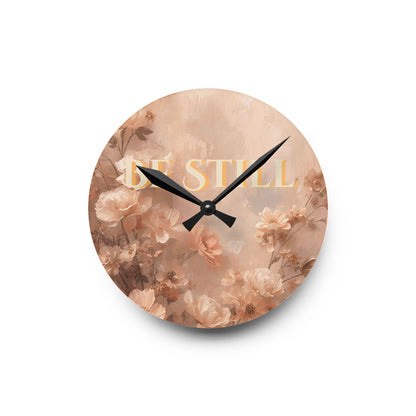 Round wall clock with floral design and 'Be Still' text on a white background
