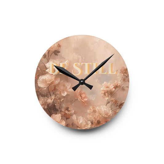 Round wall clock with floral design and 'Be Still' text on a white background