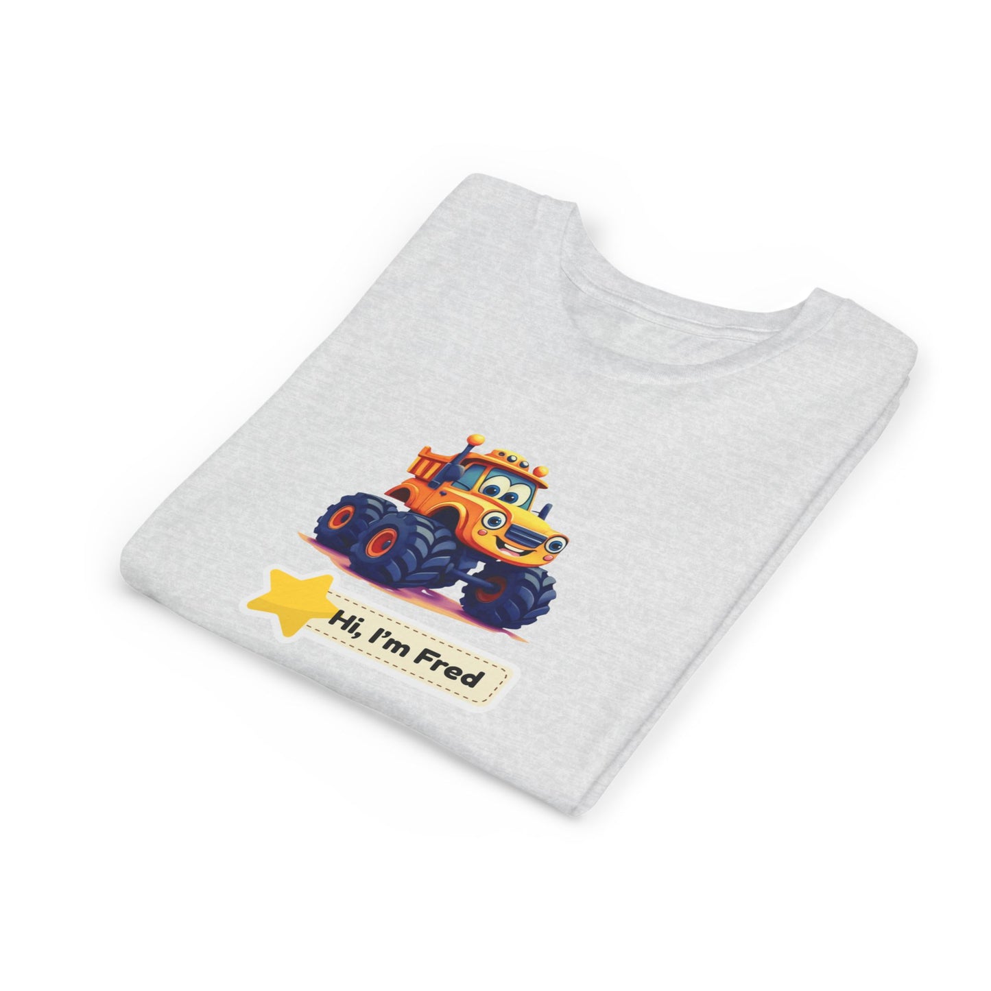 A light heather gray folded t-shirt featuring a cartoon graphic of an orange and yellow monster truck with the text 'Hi, I'm Fred' and a yellow star.