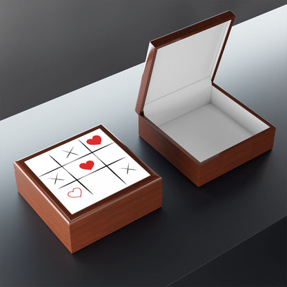 Wooden box with a white interior and a Tic-Tac-Toe game on top, featuring red hearts and Xs.