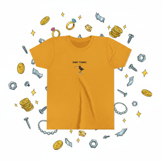Yellow mustard t-shirt with graphic image of a black crow and speech bubble that says 'MINE". The printed words: "Shiny Things"