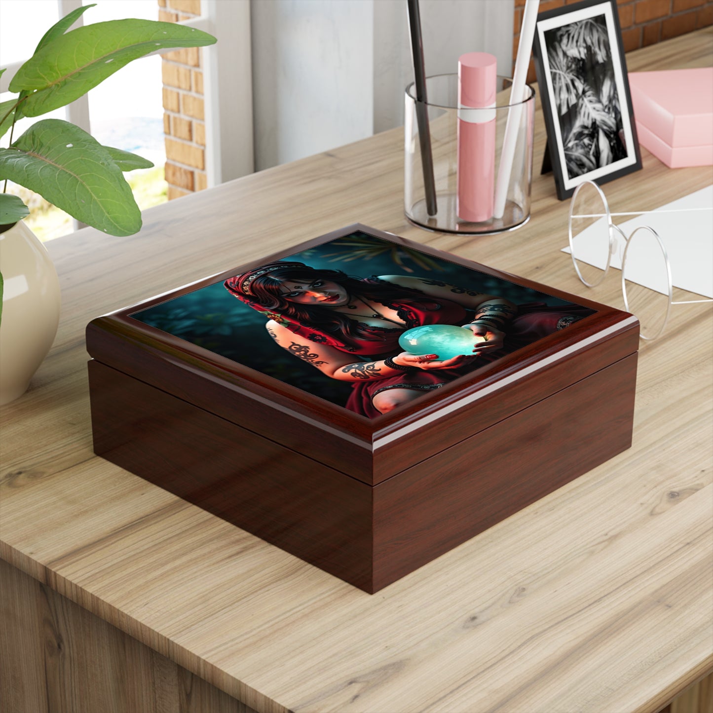Wooden box with a colorful design of a woman holding a blue globe on a wooden surface