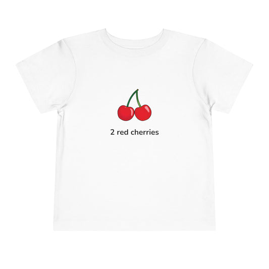 A white short-sleeve crewneck t-shirt featuring a graphic of two red cherries with green stems and the text '2 red cherries' printed below, displayed on a clean white background.