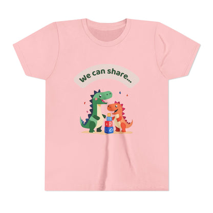 Pink t-shirt with dinosaur design and 'We can share' text on a white background