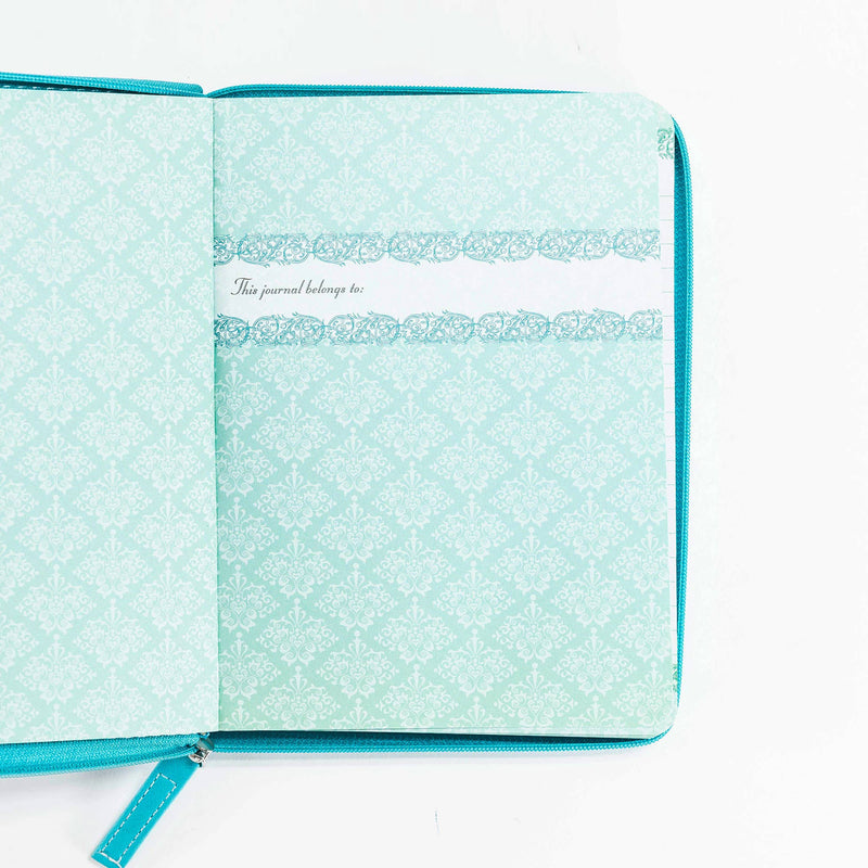 Turquoise notebook with decorative patterns on a white background
