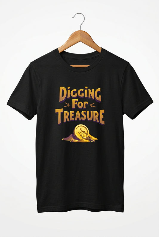 Youth “Digging for Treasure” adventure T‑shirt with bold lettering and a golden coin design, perfect for kids who love exploring and treasure hunts.  A black short-sleeve crewneck t-shirt featuring a graphic print on the front with the text 'Digging For Treasure' in a stylized gold and orange font, accompanied by a gold treasure coin illustration.