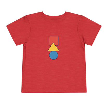 A red short-sleeve t-shirt with a central graphic of stacked geometric shapes: a red square, a yellow triangle, and a blue circle, outlined in black.