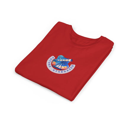A folded red t-shirt with a circular graphic on the chest featuring a blue telescope, colorful planets, and the text 'Future STARGAZER'.
