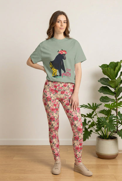 Featured tee: “Girl‑Girl™ gorilla wearing a flower crown and patterned shorts on a white unisex tee with the phrase ‘Stay Pretty.’” AI model wear the T-shirt and AI-generated flower-print pants.