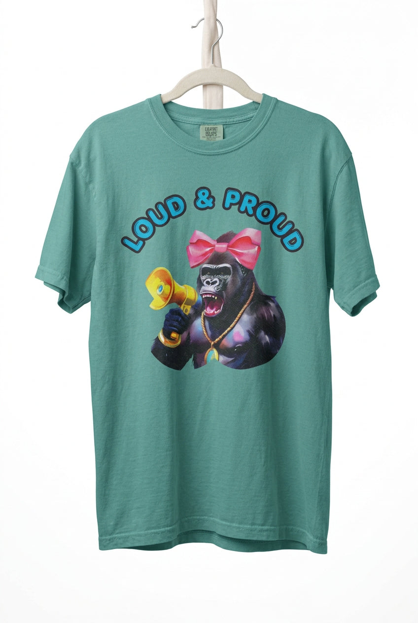 “Girl‑Girl™ cheerleader gorilla with pink bow and megaphone on a seafoam unisex tee with the phrase ‘Loud & Proud.’”
