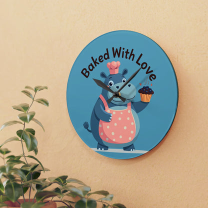 Wall clock with cartoon hippo holding a cupcake and text 'Baked With Love' on a beige wall.