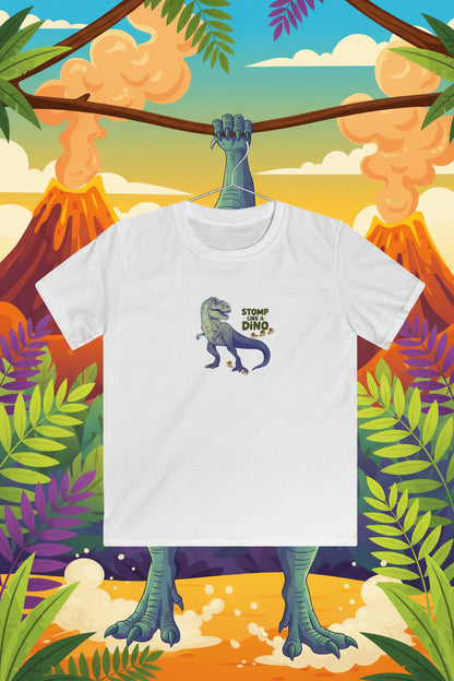 A white short-sleeve crewneck t-shirt featuring a cartoon graphic of a green and purple dinosaur with the text 'STOMP WITH DINO' on the chest, displayed against a colorful volcano background.
