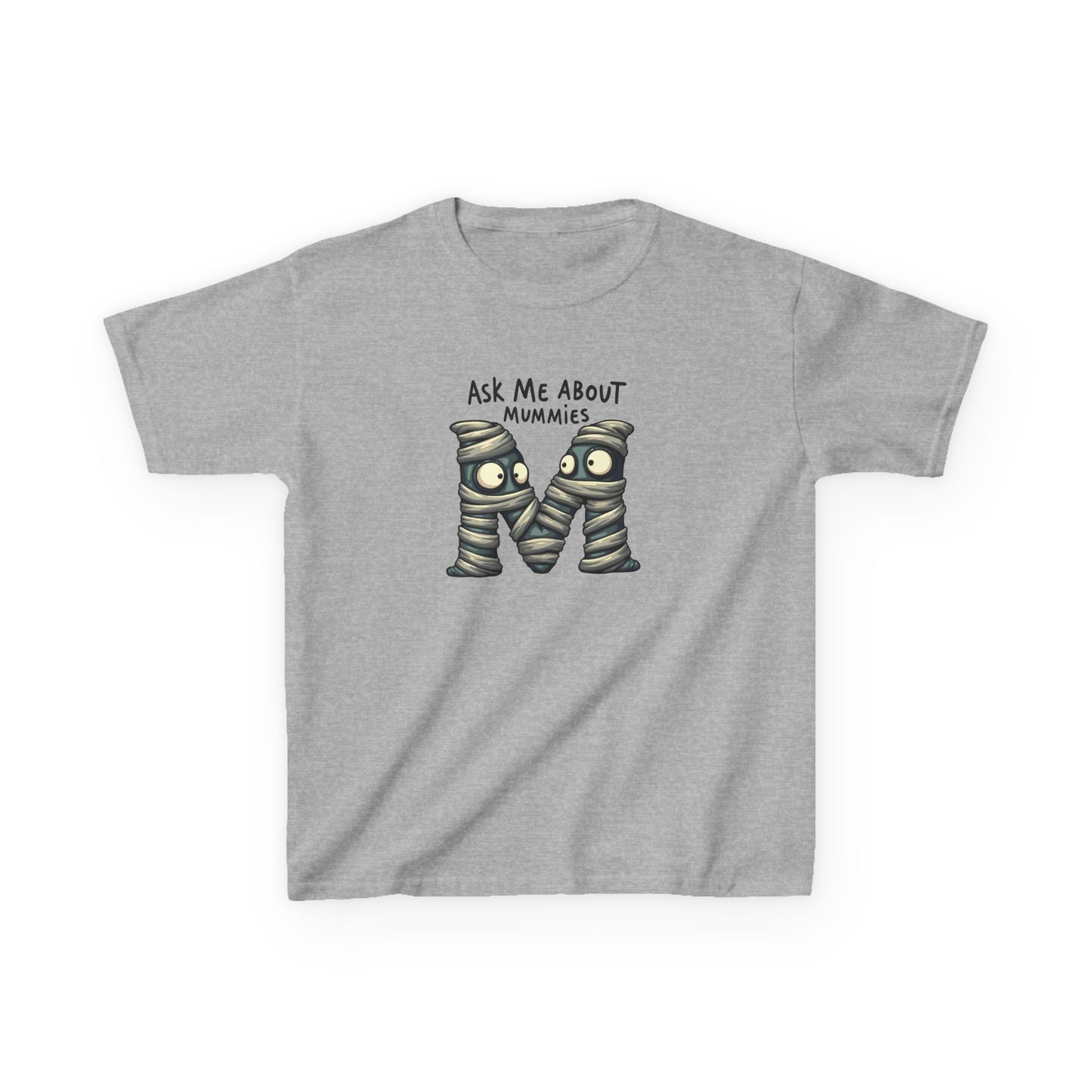 Kids history-themed shirt with “Ask Me About Mummies” design featuring cartoon mummy lettering on a Gildan 5000B Heavy Cotton Tee. Sport Grey