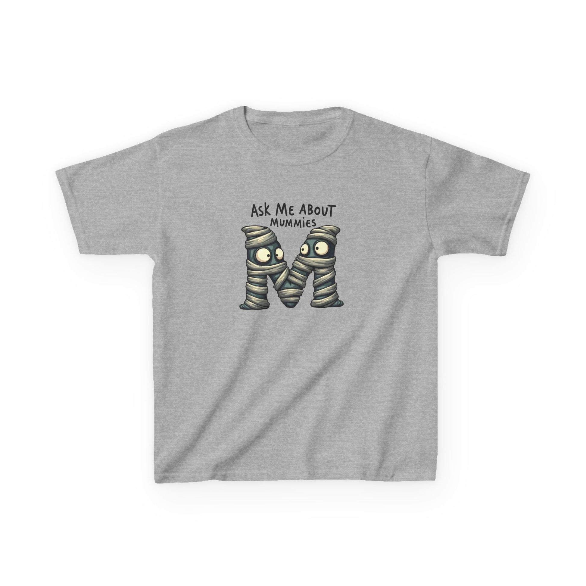 Kids history-themed shirt with “Ask Me About Mummies” design featuring cartoon mummy lettering on a Gildan 5000B Heavy Cotton Tee. Sport Grey