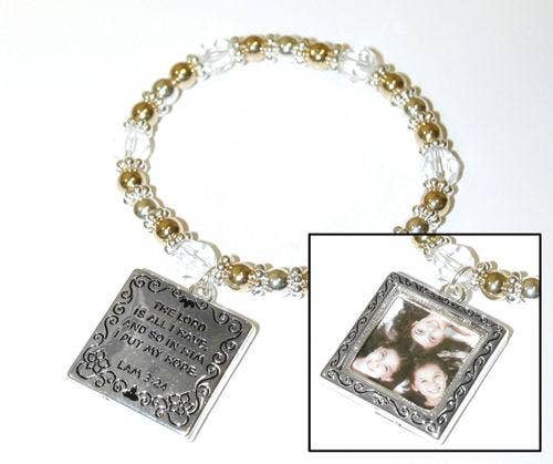 Bracelet with silver charms and a photo frame charm on a white background. Hope