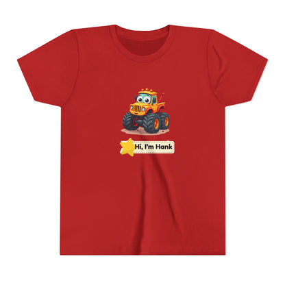A red short-sleeve crewneck t-shirt featuring a cartoon graphic of a cheerful yellow/ orange monster tires truck with a yellow star and a name tage that reads 'Hi, I'm Hank'.