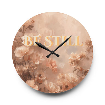 Round wall clock with floral design and 'Be Still' text on a white background