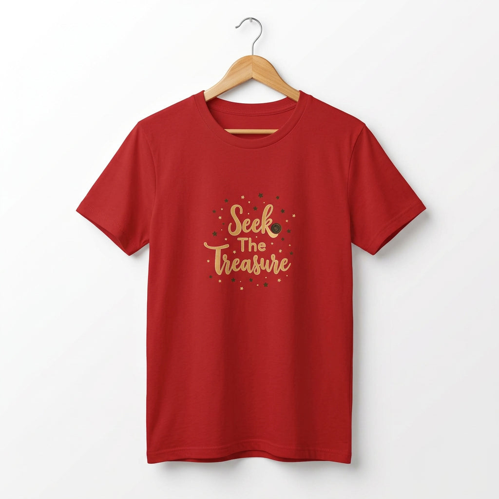 Kids red T‑shirt with golden “Seek the Treasure” lettering surrounded by small star accents. Shirt on a hanger.