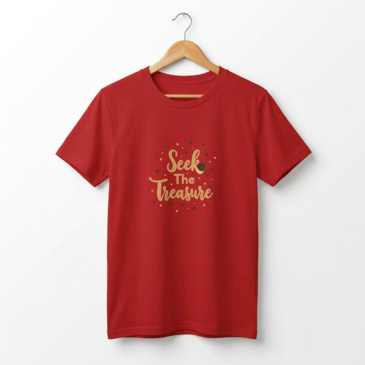 Kids red T‑shirt with golden “Seek the Treasure” lettering surrounded by small star accents. Shirt on a hanger.