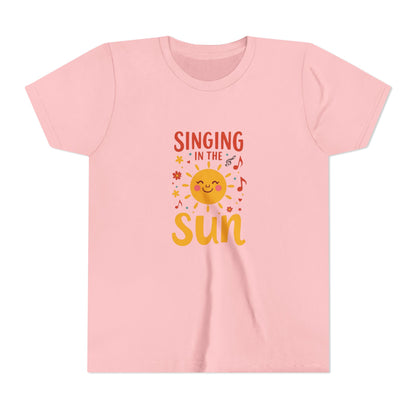 Pink t-shirt with 'Singing in the Sun' graphic design on a white background