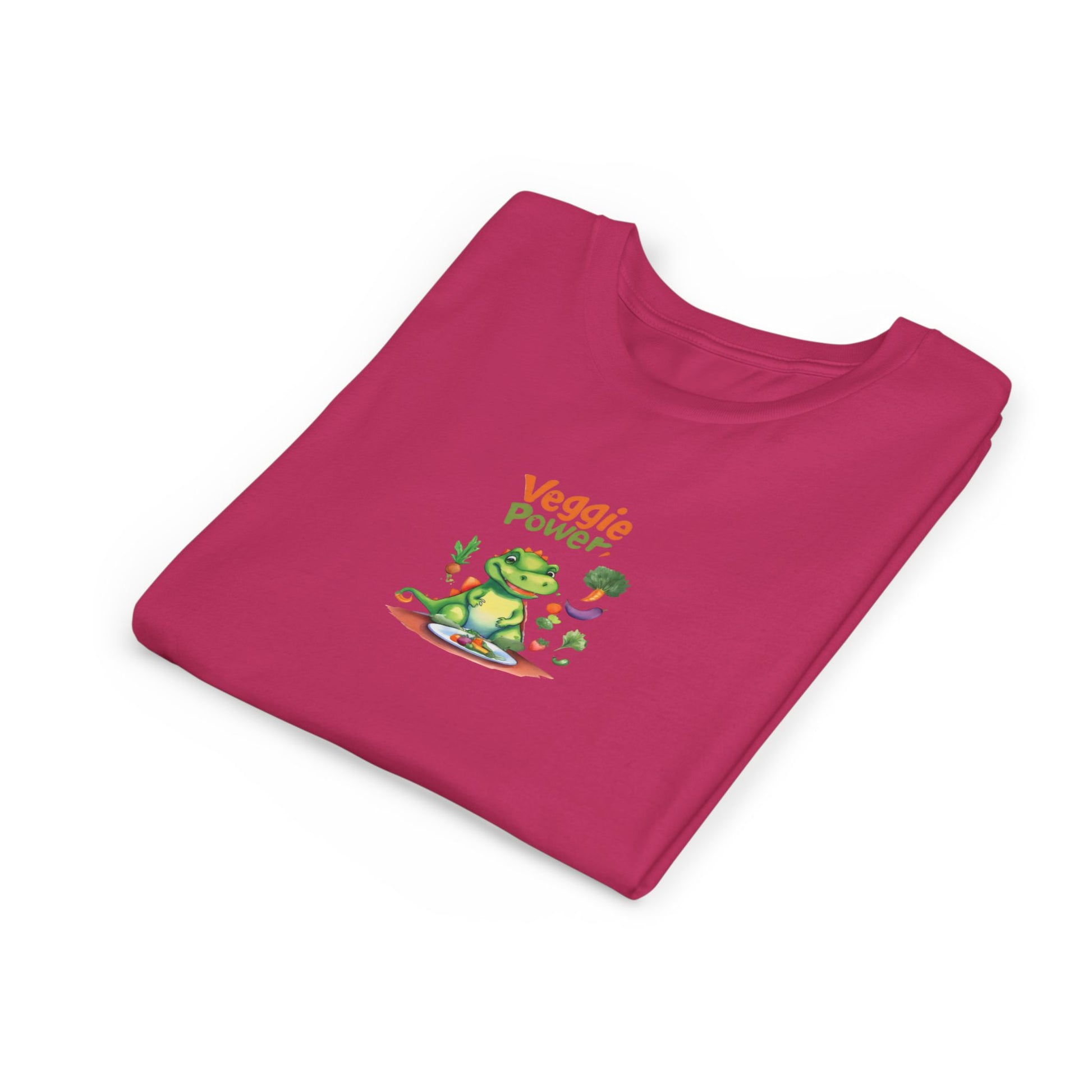 A folded magenta pink t-shirt with a cartoon graphic of a green frog wearing sunglasses and the text 'Veggie Power' in orange, displayed on a clean white background.