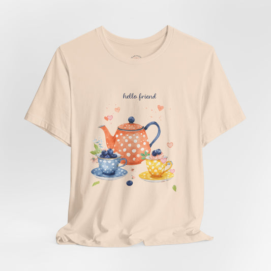 Beige t-shirt with a tea-themed graphic and 'hello friend' text on a light gray background