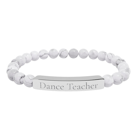 White beaded bracelet with engraved tag on a white background: dance teacher.