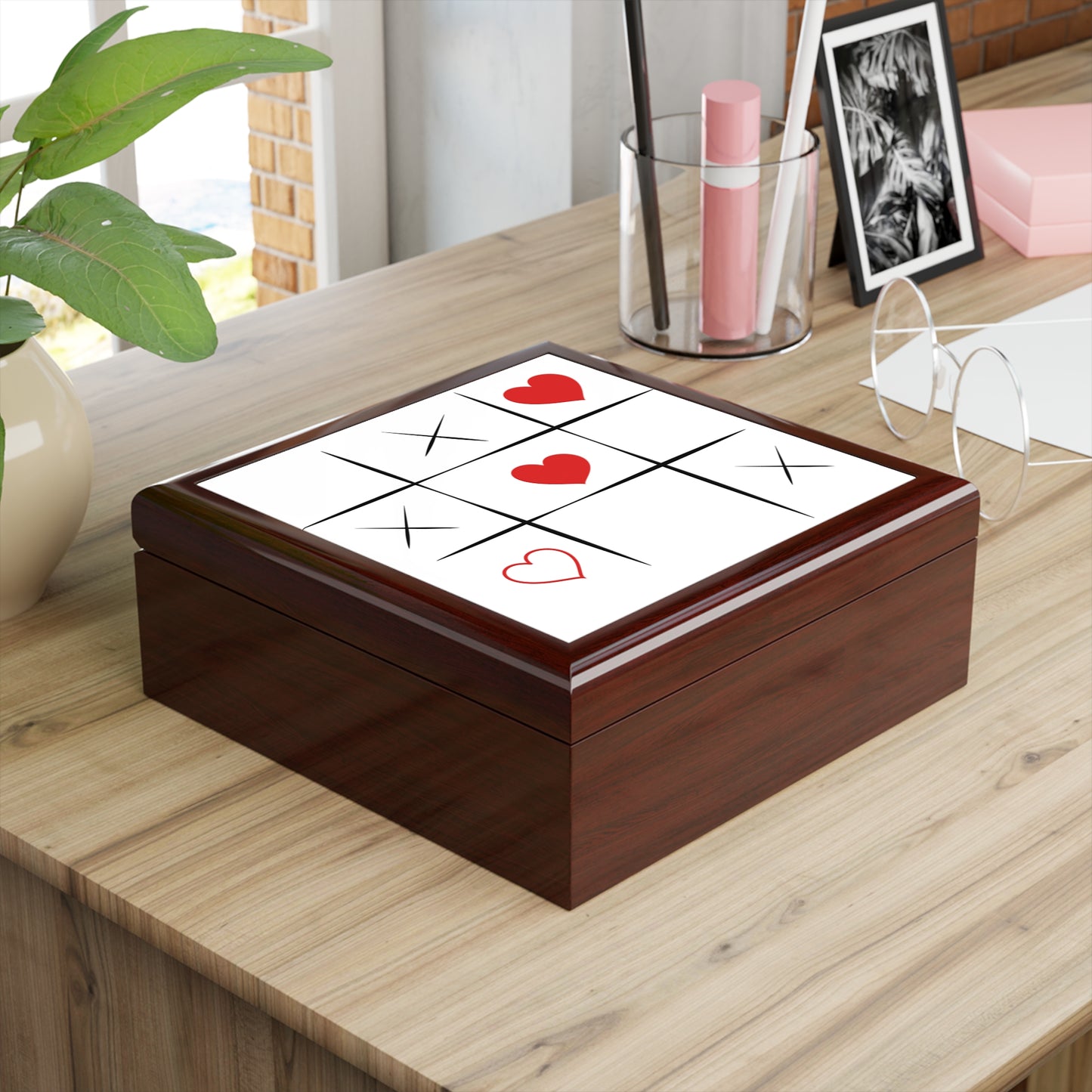Wooden box with tic-tac-toe design on a wooden surface