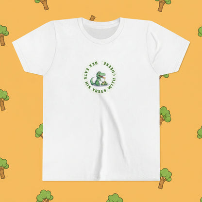 A white short-sleeve crewneck t-shirt featuring a green circular graphic on the chest with a cartoon dinosaur and the text 'Eats his TREES with CHEESE!'.
