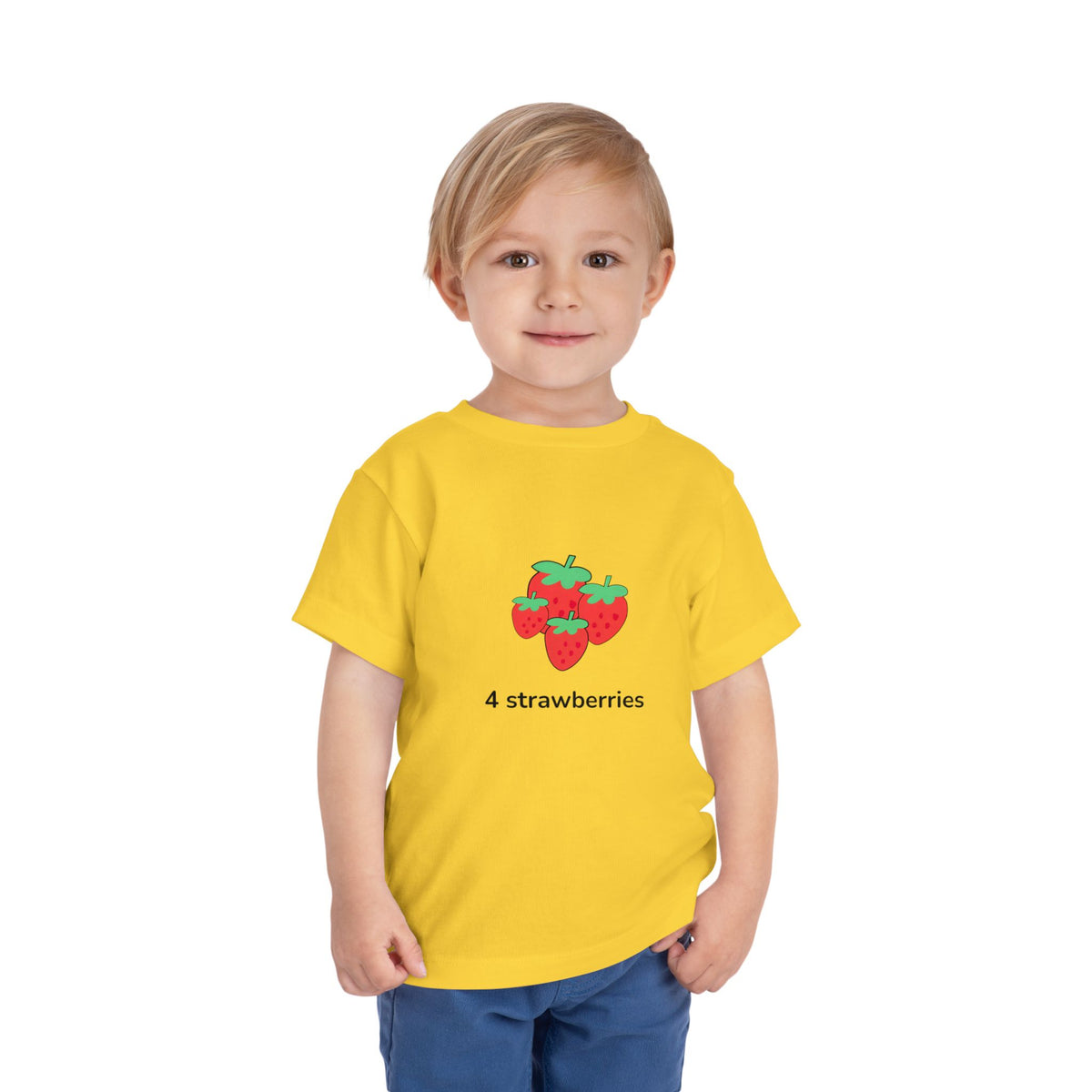 shirt with a colorful 'Fall For Snacks' graphic, paired with blue pants, standing against a plain white background.