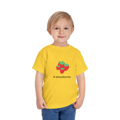 shirt with a colorful 'Fall For Snacks' graphic, paired with blue pants, standing against a plain white background.