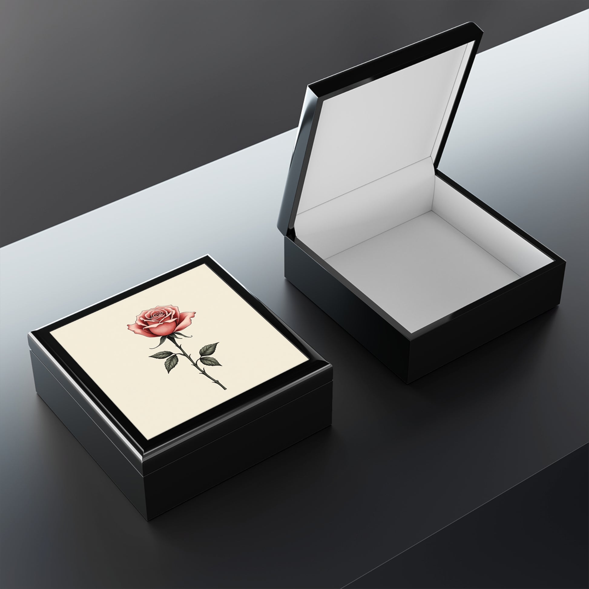 Open black jewelry box with a card inside on a dark surface